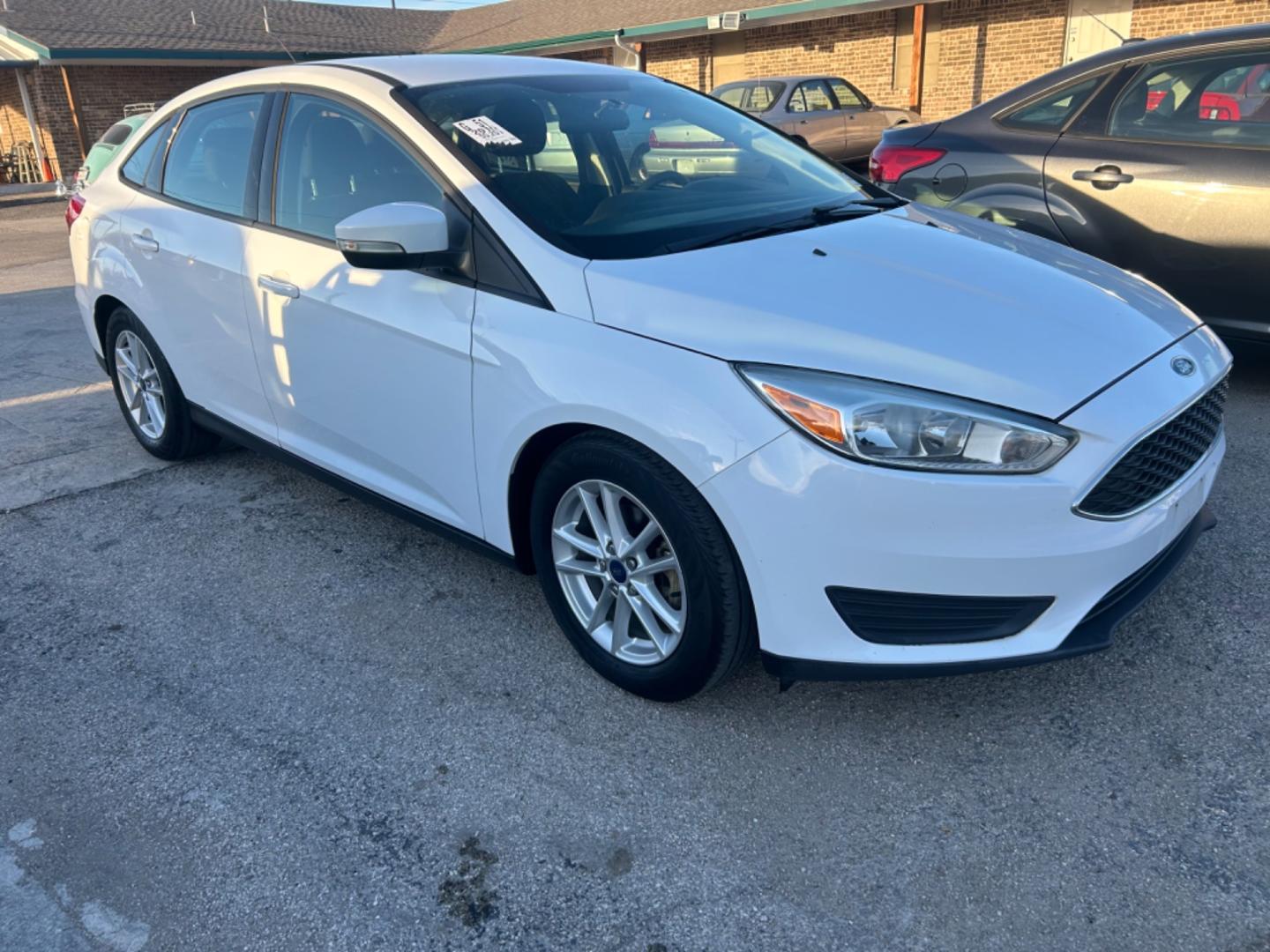 2016 White Ford Focus SE Sedan (1FADP3F28GL) with an 2.0L L4 DOHC 16V engine, located at 1687 Business 35 S, New Braunfels, TX, 78130, (830) 625-7159, 29.655487, -98.051491 - Photo#1